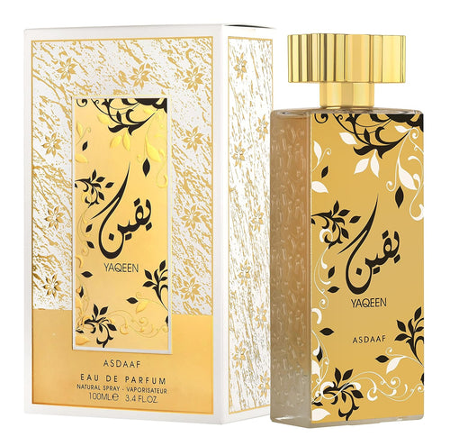 Golden and white Asdaaf Yaqeen 100ml Eau De Parfum perfume bottle with intricate patterns and Arabic calligraphy, packaged in a matching box by Dubai Perfumes.