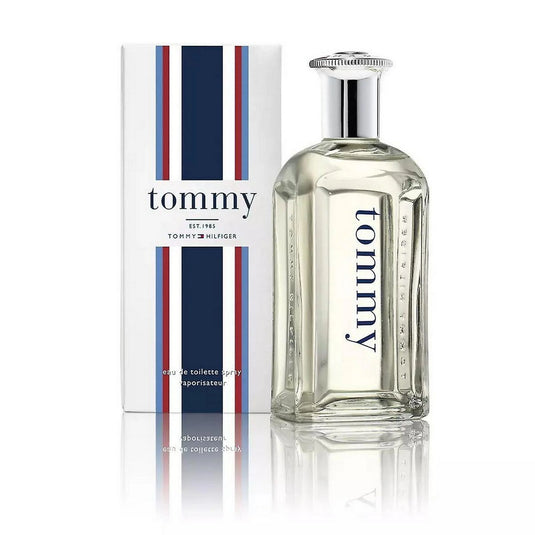 A bottle of Tommy Hilfiger Tommy Man 30ml Eau De Toilette next to its packaging with blue and red stripes on a white background.