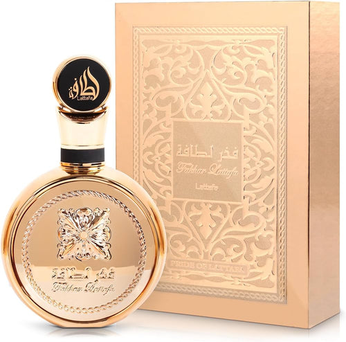 An elegant Lattafa Fakhar Gold Extrait 100ml Eau de Parfum bottle with Arabic script and ornate design, accompanied by its matching decorative box, ideal as a fragrance for women.