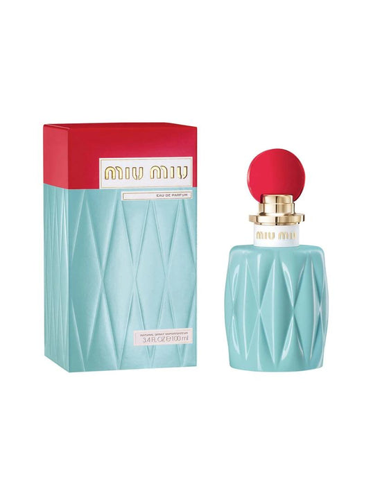 Image of MIU MIU miniature 7ml Eau De Parfum mini. The bottle, embodying a floral fragrance, is light blue with a red circular cap and gold accents. The packaging box mirrors this with its light blue and red top, proudly displaying the brand name 