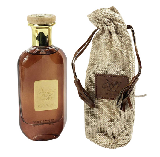 A bottle of Ard Al Zaafaran Mousuf 100ml Eau De Parfum with a brown bag next to it.