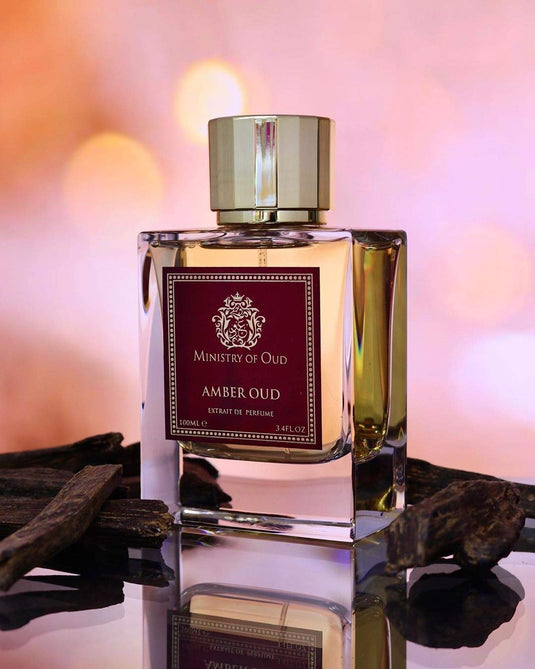 A bottle of Ministry of Oud Amber Oud 100ml Extrait De Parfum by Dubai Perfumes on a table.