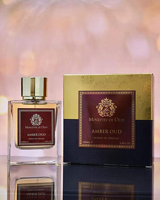 A bottle of Ministry of Oud Amber Oud 100ml Extrait De Parfum by Dubai Perfumes next to a box.