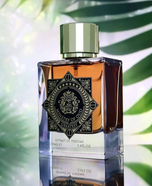 A bottle of Paris Corner Ministry of Oud Greatest 100ml Extrait de Perfume by Dubai Perfumes sitting on top of a leaf.
