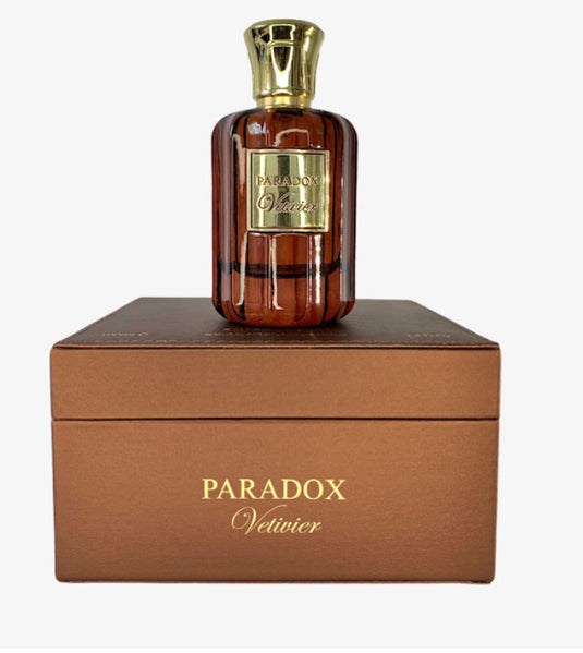 A bottle of Paris Corner Paradox Vetivier 100ml Eau De Parfum by Dubai Perfumes sitting on top of a brown box.