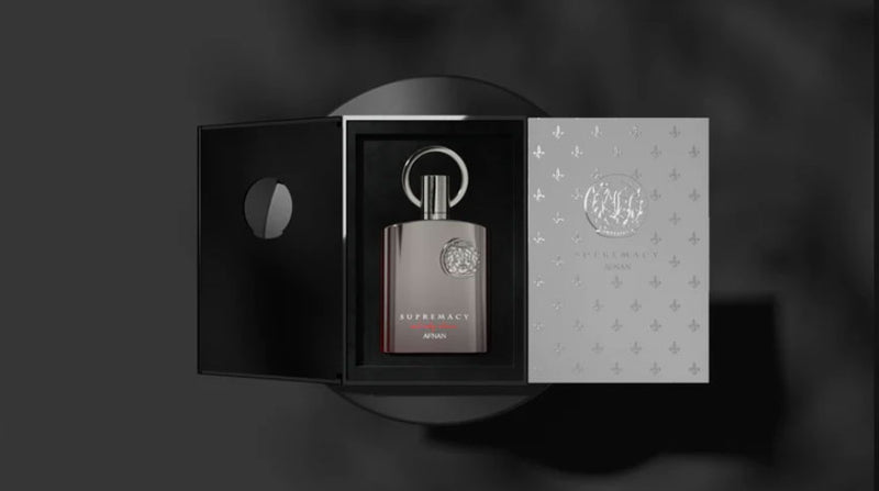 Load image into Gallery viewer, A bottle of Afnan Supremacy Not Only Intense 100ml Extrait de Parfum by Rio Perfumes in a box on a black background.
