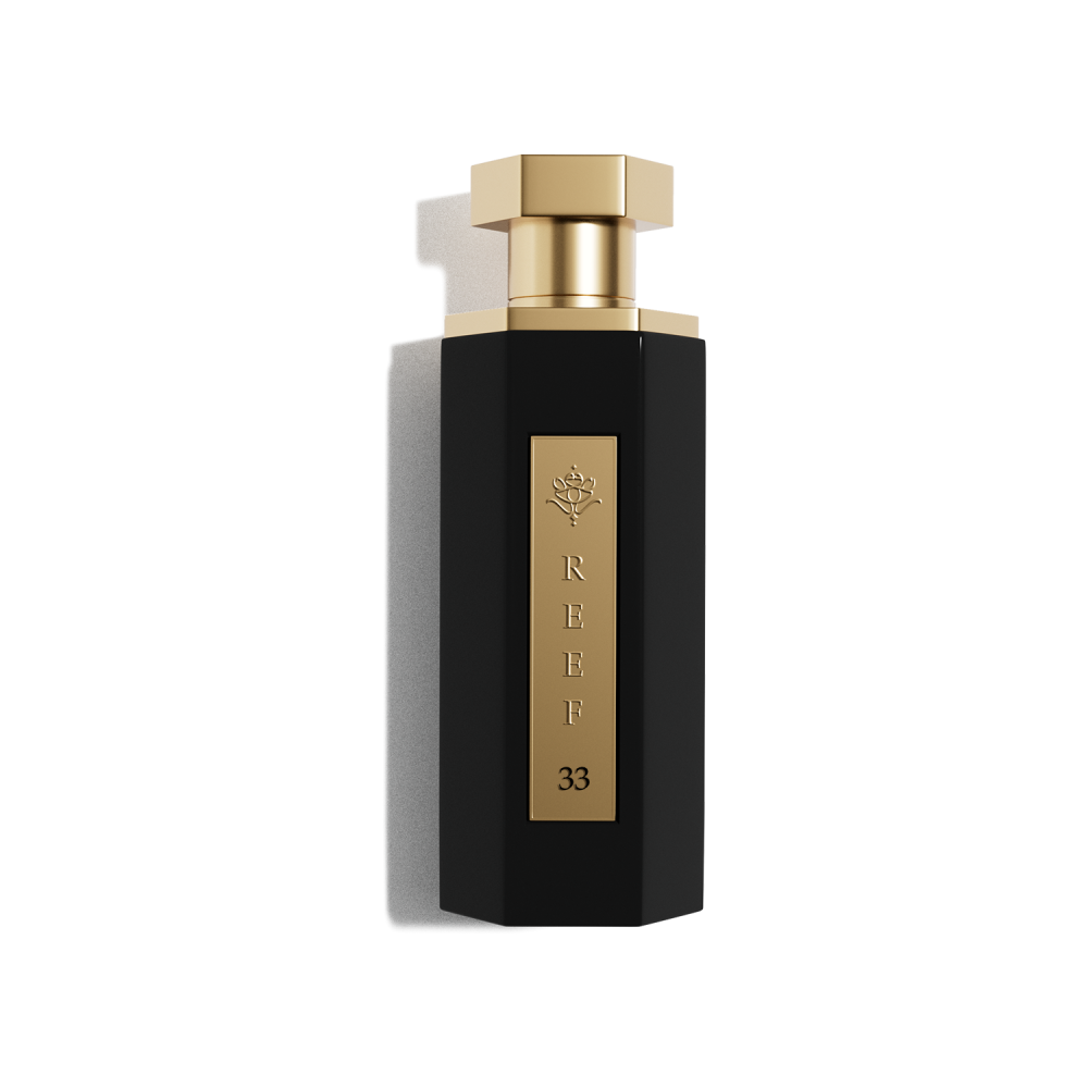 Reef 33 100ml EDP by Reef features a black hexagonal bottle with gold accents and a gold cap, labeled "REEF 33". This unisex Eau De Parfum offers a bold and sophisticated fragrance for those who appreciate elegance.