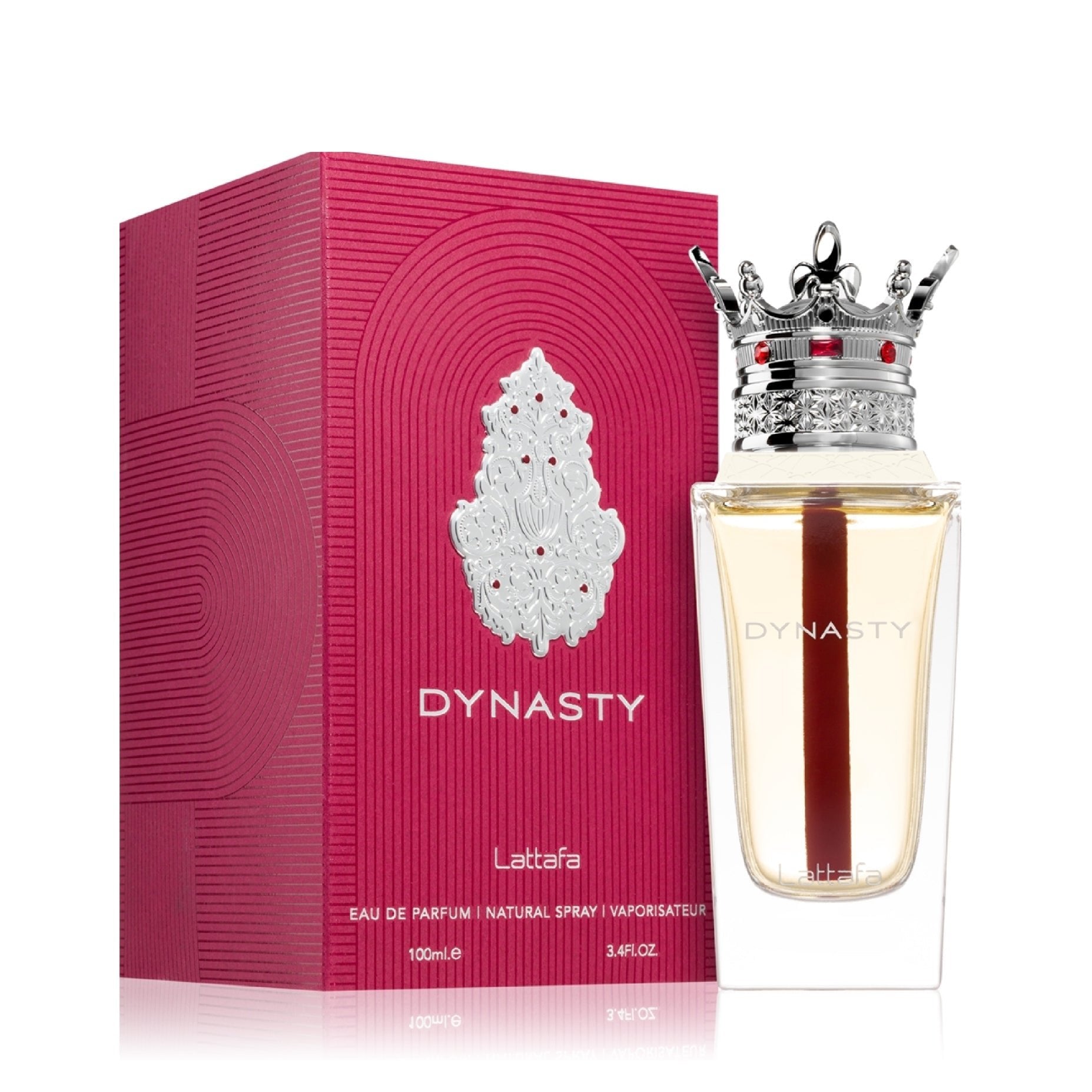 A bottle of Lattafa Dynasty 100ml EDP, with a crown-shaped cap, stands next to its pink textured box with silver details, showcasing the elegance of this unisex fragrance by Lattafa.