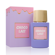 A bottle of Paris Corner Choco Lait 100ml EDP, a unisex perfume with a ribbed gold cap, rests beside its pastel purple and pink box with a gold wavy line, reflecting the gourmand essence of this Paris Corner fragrance.
