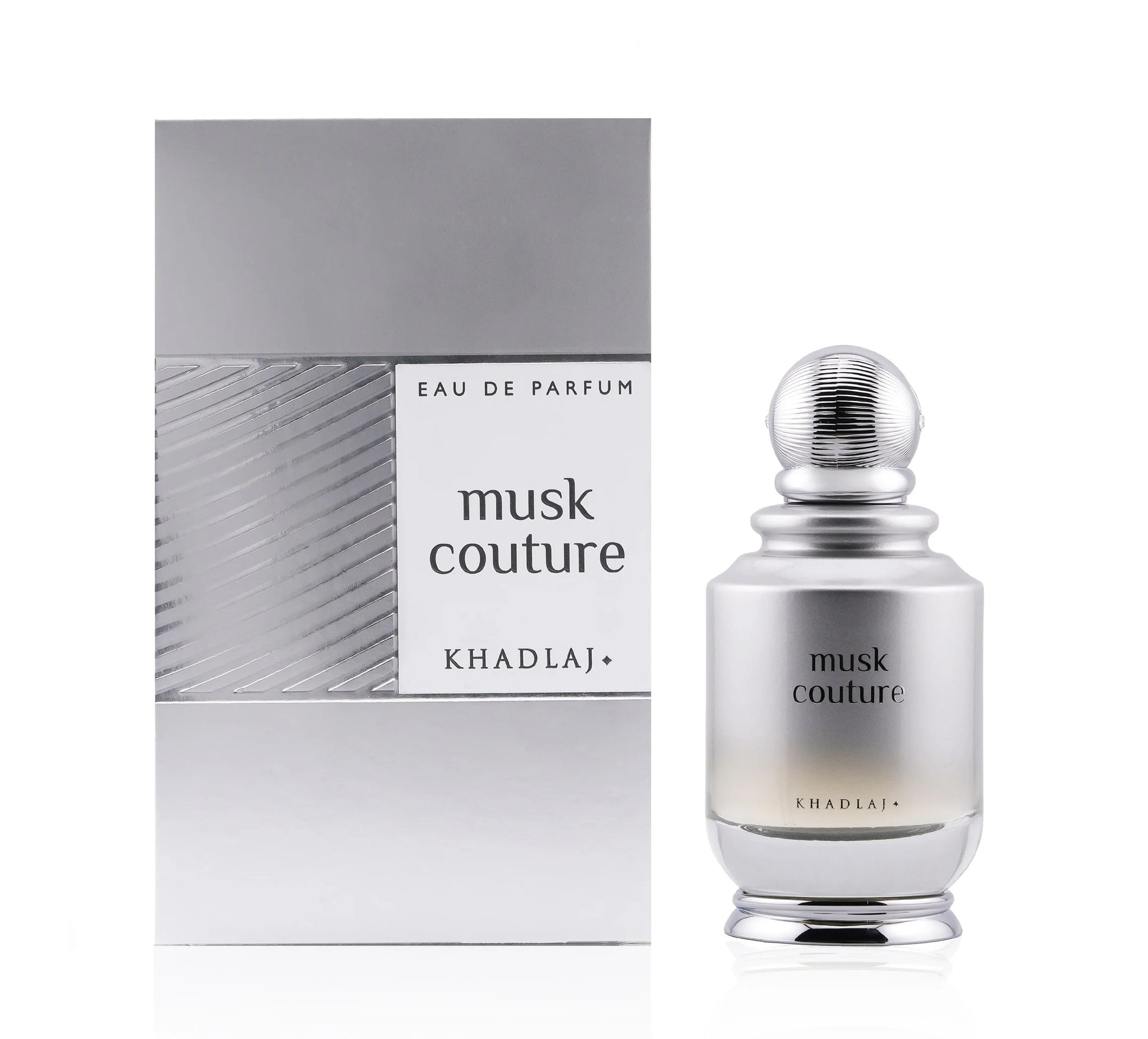 A 100ml bottle of Khadlaj Musk Couture by Khadlaj, a refined unisex fragrance, is shown beside its coordinating silver and white packaging box.