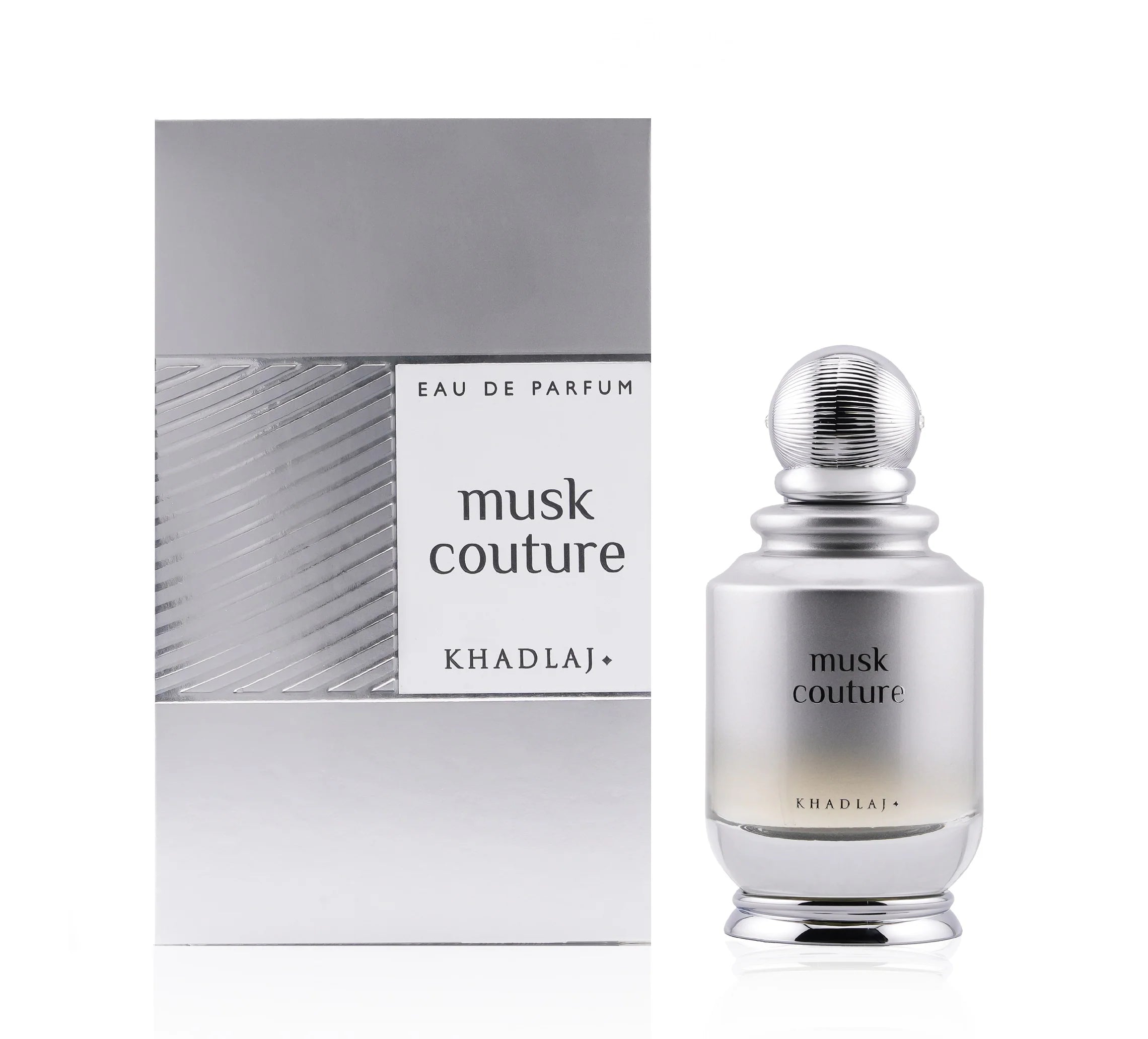A 100ml bottle of Khadlaj Musk Couture by Khadlaj, a refined unisex fragrance, is shown beside its coordinating silver and white packaging box.