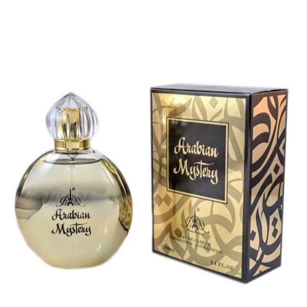 A bottle of Paris Corner Arabian Mystery 100ml Eau De Parfum by Dubai Perfumes, featuring a round gold-tinted design, is displayed beside its elegant black and gold patterned packaging.
