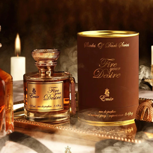 A bottle of Emir Fire your Desire 100ml Eau De Parfum by Paris Corner on a tray next to candles.