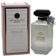 A boxed Fragrance World Rose Seduction Secret Reveal Cloud Of Crème 100ml EDP stands beside its matching glass bottle with a black cap and bow, capturing the oriental gourmand essence of this Eau De Parfum.