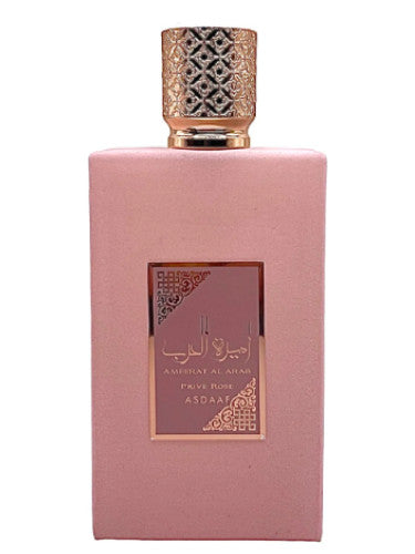 A pink perfume bottle with an ornate gold cap features the label "Asdaaf Ameerat Al Arab Prive Rose" by Rio Perfumes. This Eau De Parfum delivers a captivating Floral Fruity fragrance that enchants any room.