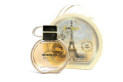 Emper Memories Pour Femme 100ml EDP by Emper is shown before its round box, adorned with an Eiffel Tower illustration—a fitting touch for this unforgettable floral green fragrance.