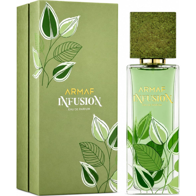 A green box and glass bottle of Armaf Infusion 80ml EDP, both adorned with white and green leaf patterns and gold lettering, present this citrus aromatic fragrance from Armaf. This unisex Eau de Parfum captures freshness and elegance in every detail.