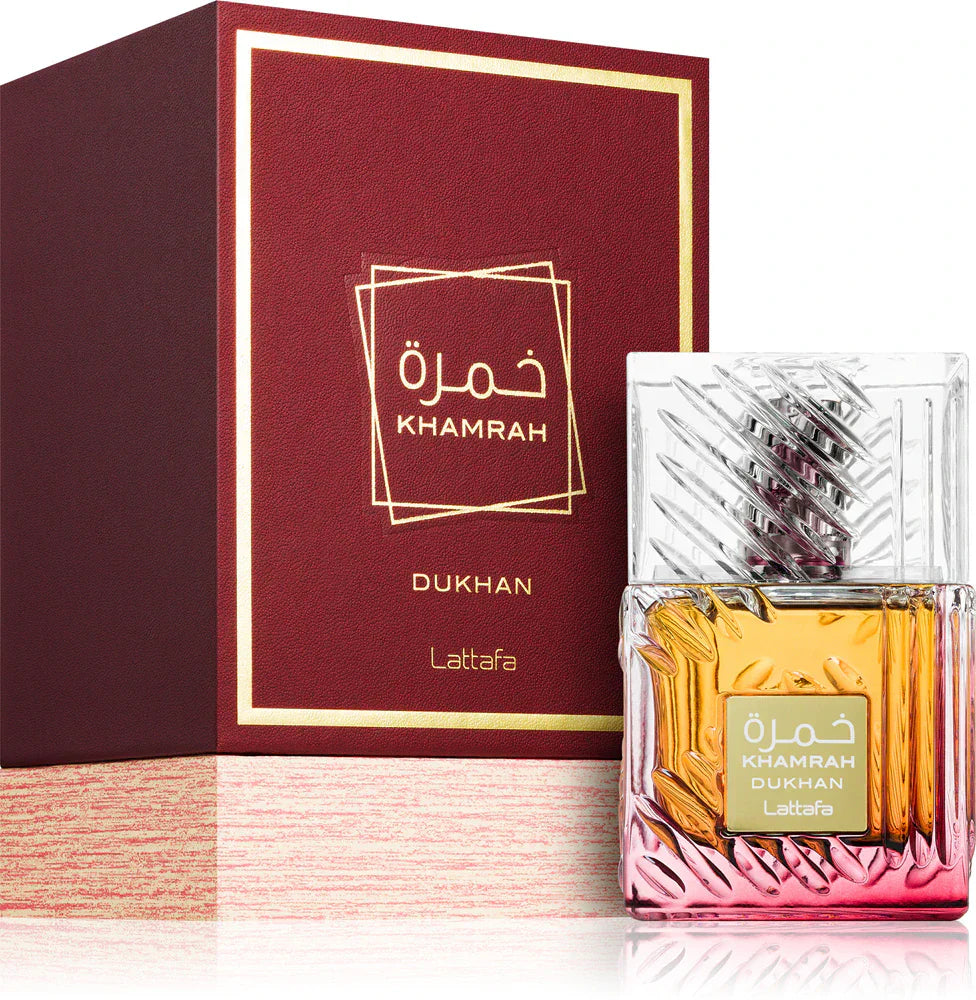 Lattafa Khamrah Dukhan 100ml Eau De Parfum by Lattafa is shown beside its elegant red and gold box, highlighting this luxurious unisex fragrance.