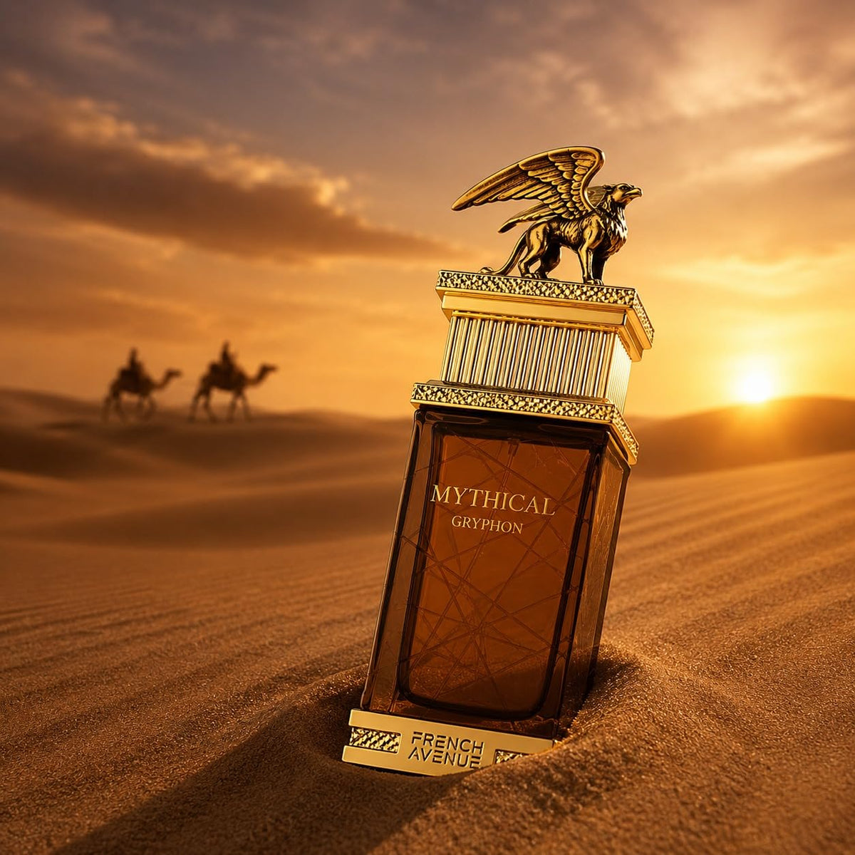 A bottle of French Avenue Mythic Gryphon 100ml EDP, a luxurious men’s perfume from French Avenue with an oriental spicy fragrance, rests on desert sand at sunset. Its gold gryphon cap gleams as two camels and their riders pass by in the softly blurred background.