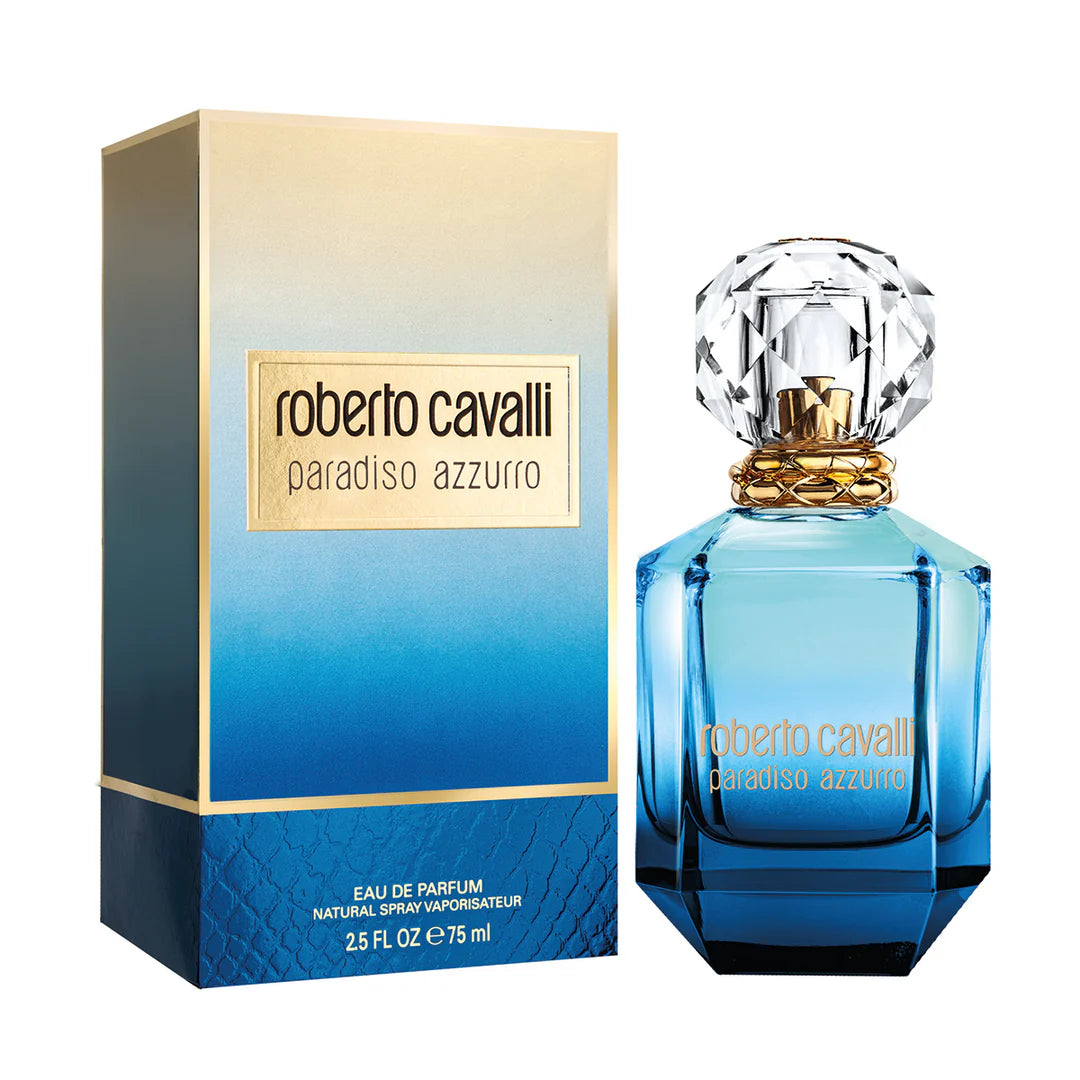 A blue glass bottle of Roberto Cavalli Paradiso Azzurro 75ml EDP by Roberto Cavalli, a floral aromatic fragrance, is displayed next to its matching blue and gold packaging box.