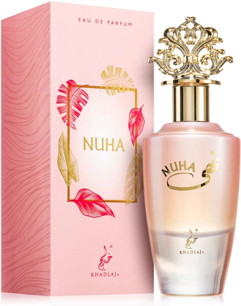 A pink and gold Khadlaj Nuha 85ml unisex perfume bottle stands beside its matching decorative pink box.