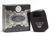 A black bottle of Ard Al Zaafaran Dar Al Shabab 100ml Eau de Parfum stands beside its elegant black and silver box, both featuring Arabic and English text. This unisex fragrance is from the Ard Al Zaafaran brand.