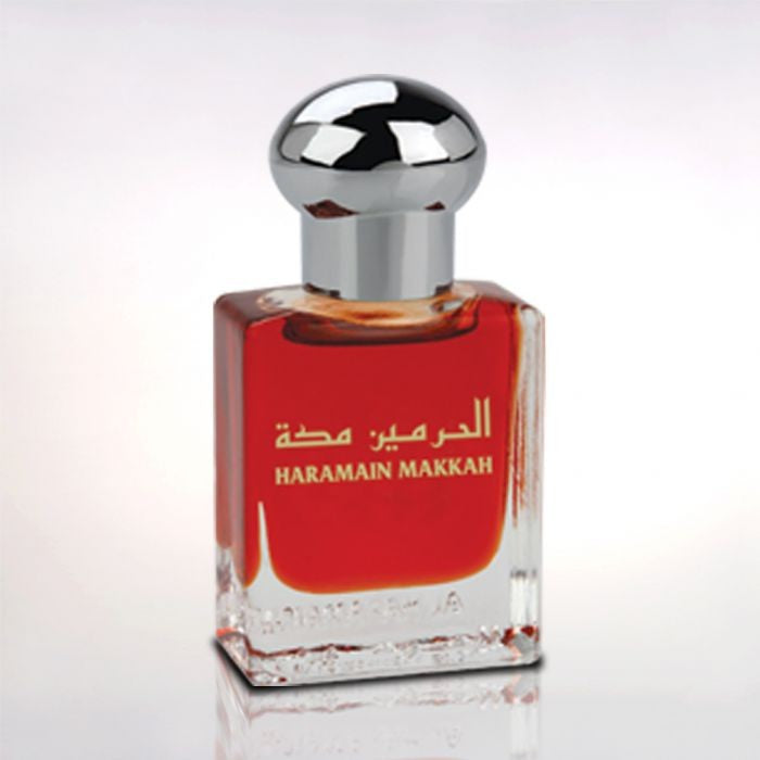 Load image into Gallery viewer, A bottle of Al Haramain Makkah Pure Perfume 15ml with Arabic writing on it, containing rich fragrance notes.
