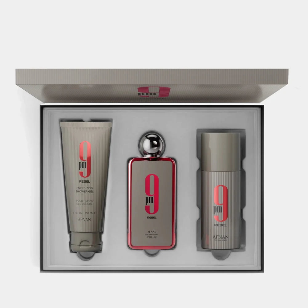 The Afnan 9PM Rebel 100ml EDP Gift Set by Afnan features a shower gel, an Eau De Parfum (100ml), and a deodorant—each infused with the captivating unisex scent—elegantly presented in a sleek white box.