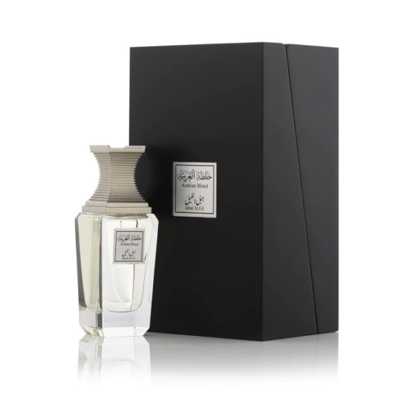 A bottle labeled "Arabian Oud Arabian Blend Jabal Al Fil 100ml Eau De Parfum" stands next to a black box, both with silver labels. This Eau De Parfum offers a captivating fragrance for men and women.