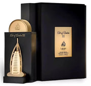 A gold and black architecturally designed perfume bottle stands beside its box labeled "Lattafa Art of Arabia III 100ml Eau de Parfum" by Lataffa, featuring a luxurious citrus aromatic fragrance.
