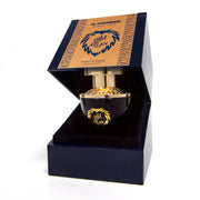 A bottle of AL Haramain Azlan Oud Bleu Edition 100ml Extrait De Parfum by AL Haramain sits in an open blue and gold box, displaying the ornate bottle inside.
