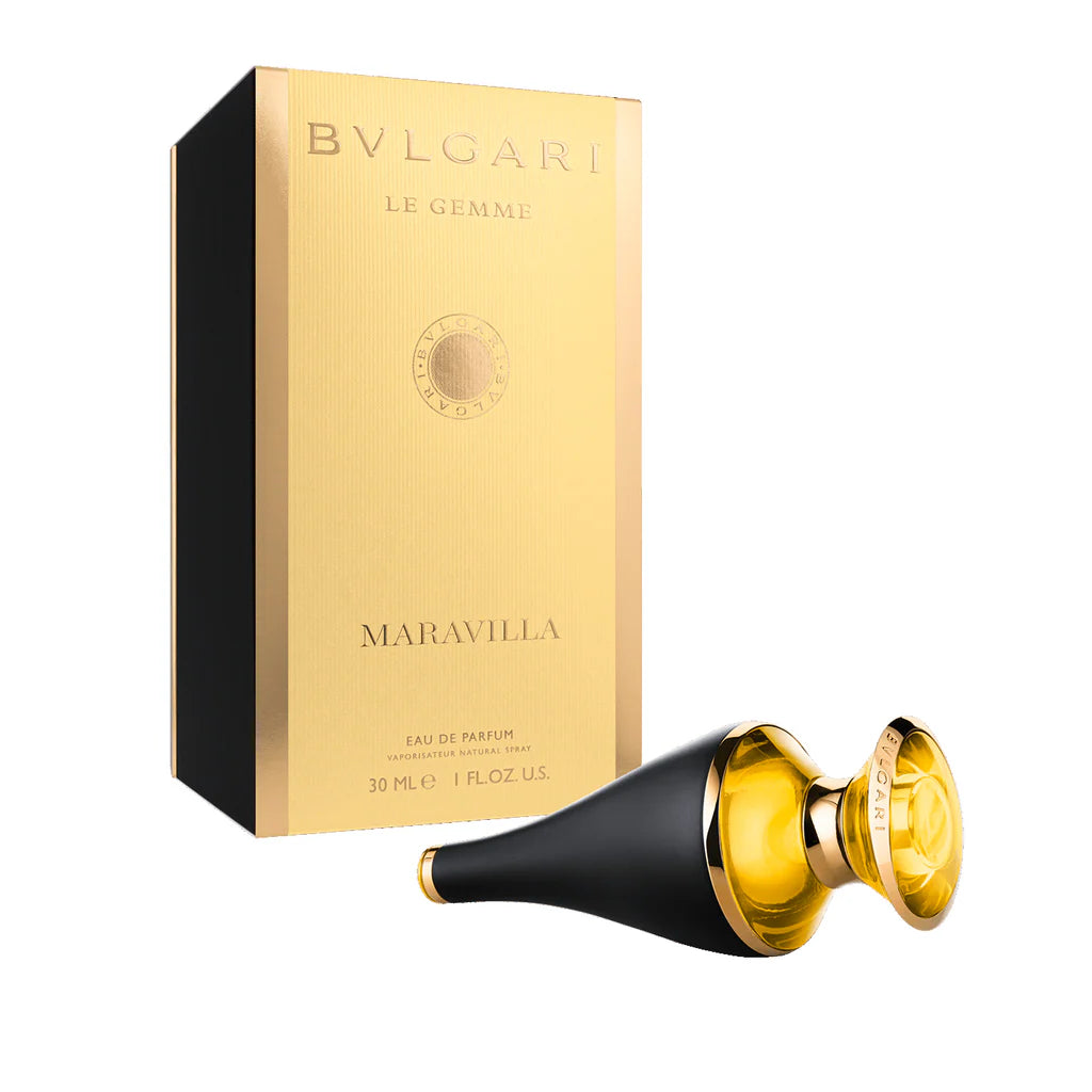 A Bvlgari Le Gemme Maravilla 30ml EDP box sits beside a unique black and gold bottle, lying on its side—a refined floral fruity fragrance for women from Bvlgari.