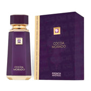 A purple bottle of French Avenue Cocoa Morado 100ml EDP is displayed beside its matching purple and gold box, showcasing the essence of this luxurious Oriental Woody fragrance.