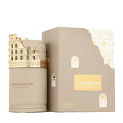 A beige Fragrance World Colosseum 100ml EDP perfume bottle adorned with a gold Colosseum design is displayed beside its matching box, both from Fragrance World, reflecting the character of an oriental woody fragrance.