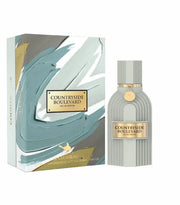 A bottle of Le Chameau Boulevard by Le Chameau sits beside its matching box, which features abstract teal, white, and gold designs.