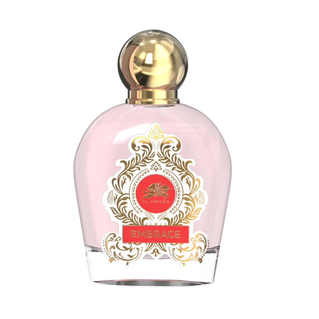 The Al Fares Embrace Absolute 100ml Eau De Parfum by Rio Perfumes features a pink bottle with a gold cap, adorned with an ornate gold design and a red emblem on the front.
