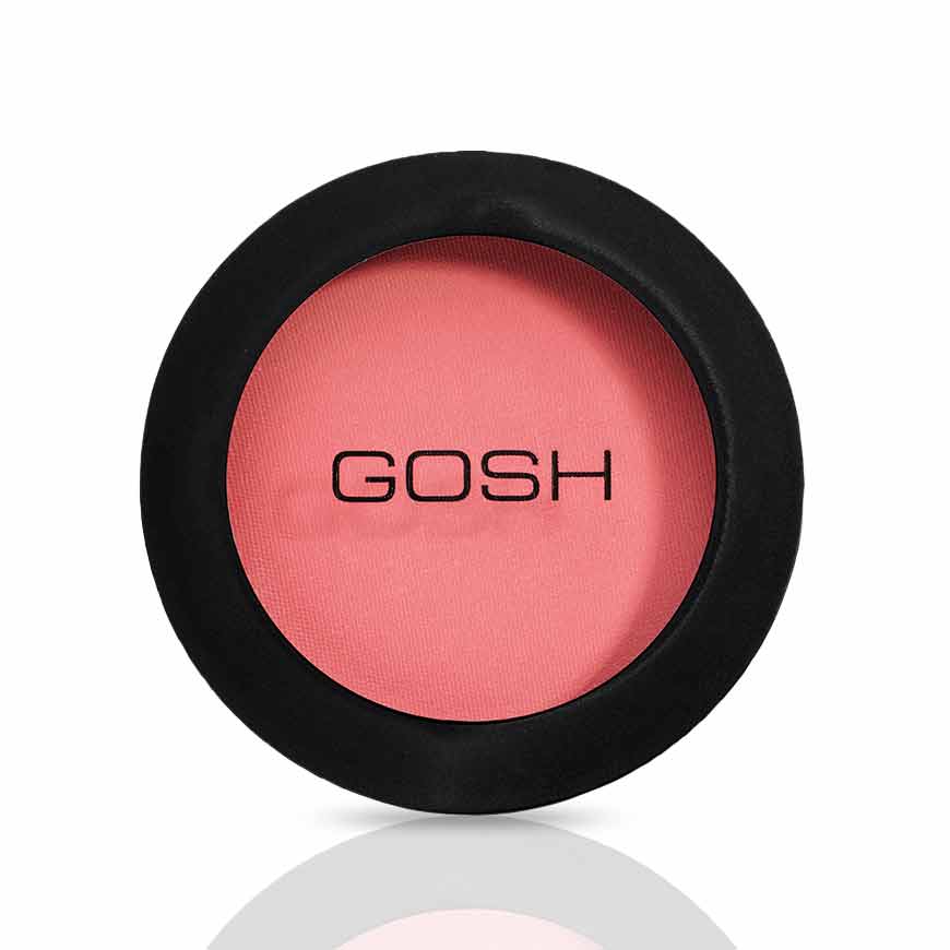 A round black compact with “GOSH” printed on the lid, containing Gosh Natural Blush Flower Power, a long-lasting pink blush powder.
