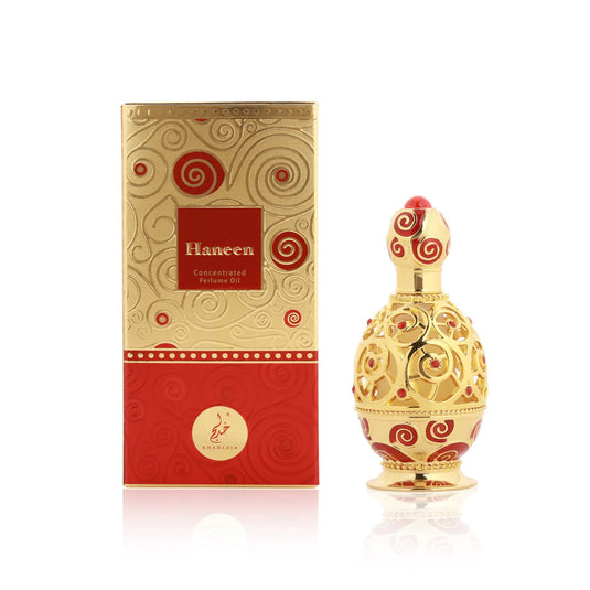 A red and gold Dubai Perfumes Khadlaj Haneen Gold Concentrated Perfume Oil 20ml bottle with a box next to it.