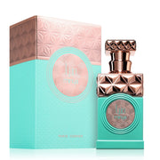 A turquoise and gold bottle with a geometric design sits elegantly beside its matching box, displaying "Paris Corner" and "Minya 100ml." This enchanting unisex Eau de Parfum offers hints of sandalwood.