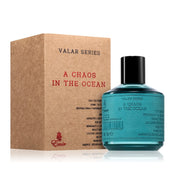 A teal glass bottle labeled "Emir Vala Series A Chaos in the Ocean 100ml Eau De Parfum" by Paris Corner stands beside a matching brown box.