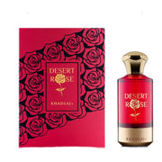 A luxurious Khadlaj Desert Rose 100ml Extrait De Parfum bottle in red and gold stands beside a matching red box with black rose designs and gold accents, highlighting this signature fragrance by Khadlaj.