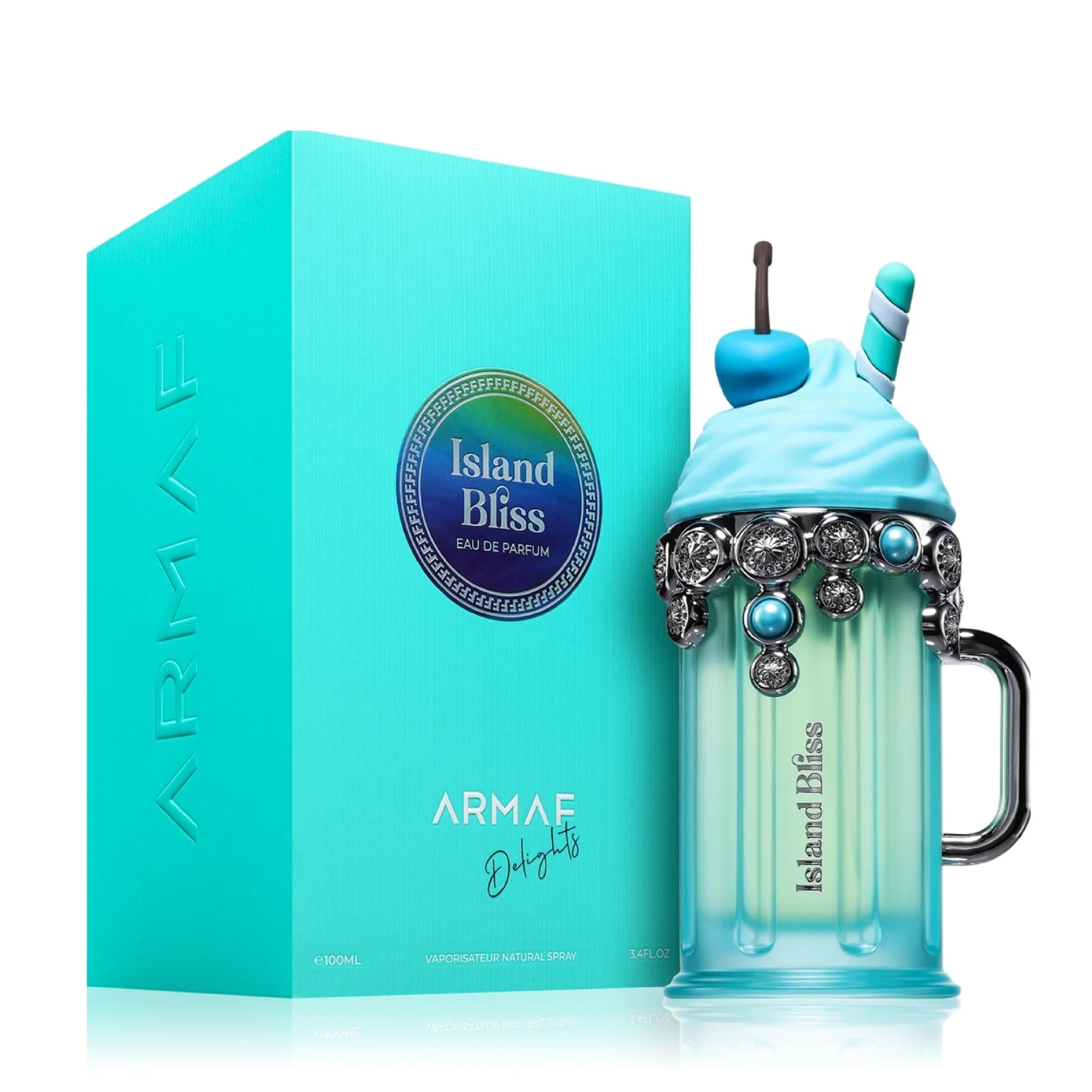 A turquoise "Armaf Delights Island Bliss 100ml EDP" box sits beside a milkshake-shaped perfume bottle with blue accents, straw, whipped cream cap, and handle—reflecting the playful flair of this floral fruity Armaf fragrance for women.