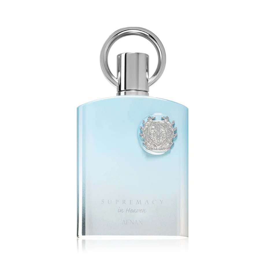 Afnan Supremacy in Heaven 100ml EDP by Afnan is a men's perfume in a light blue gradient bottle with a silver cap and ornate silver emblem, embodying the woody aromatic scent.