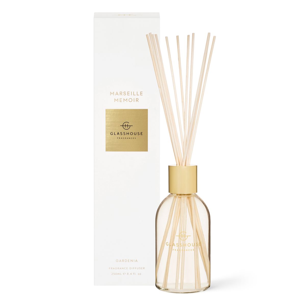 A 250ml glass diffuser with natural reeds and a gold cap from Rio Perfumes sits by its white and gold "Glasshouse Marseille Memoir" box, releasing peony notes with a touch of pink suede.