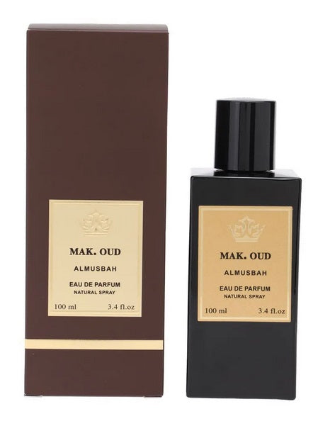 A bottle of "Almusbah MAK. Oud" eau de parfum by Rio Perfumes, infused with Amber Woody fragrance, next to its brown packaging box, both labeled for 100 ml natural spray.