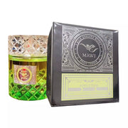 A 100ml glass bottle of Paris Corner Mawj Appletini Eau De Parfum by Rio Perfumes, featuring green liquid, is displayed next to its black and yellow box—an invigorating unisex fragrance.