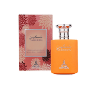 A Paris Corner Taskeen 100ml Eau De Parfum bottle in orange sits next to its pink and red floral-patterned box.