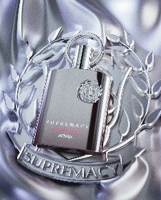 Afnan Supremacy Not Only Intense 100ml Extrait de Parfum stands in a silver laurel wreath on a shiny, fabric-like background—a striking fragrance for men and women by Afnan.