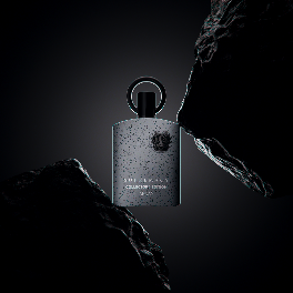 Afnan Supremacy Collectors Edition 100ml EDP, a refined men’s fragrance by Afnan, stands between two black rocks on a dark background, embodying exclusive bold sophistication.