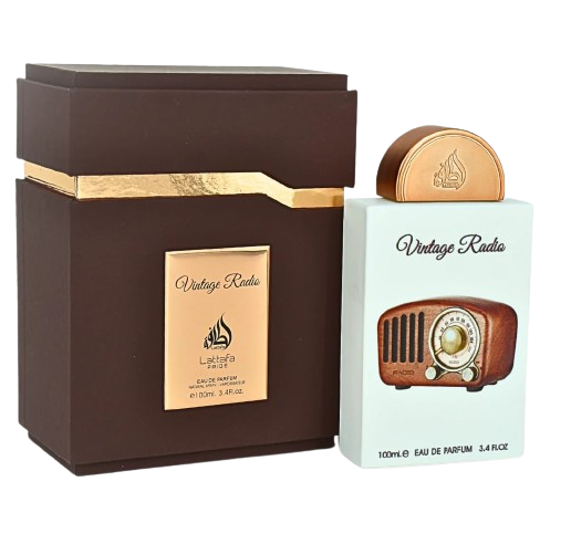 A brown and gold box stands beside a Lattafa Pride Vintage Radio 100ml Eau De Parfum bottle, labeled "Vintage Radio" by Lattafa and adorned with a retro radio design—an elegant unisex fragrance for any collection.